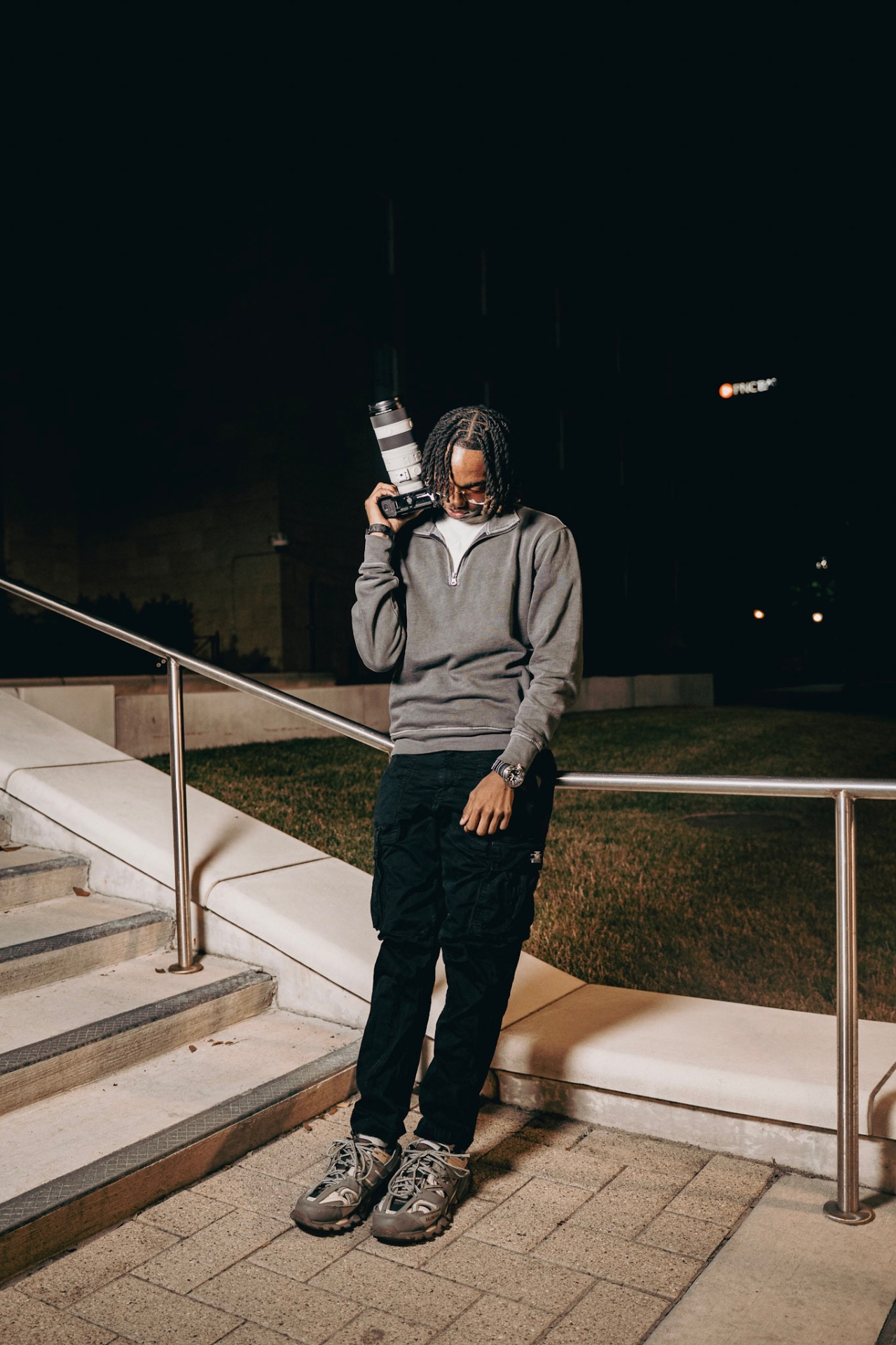 Holy Visuals founder with camera at night in Baltimore