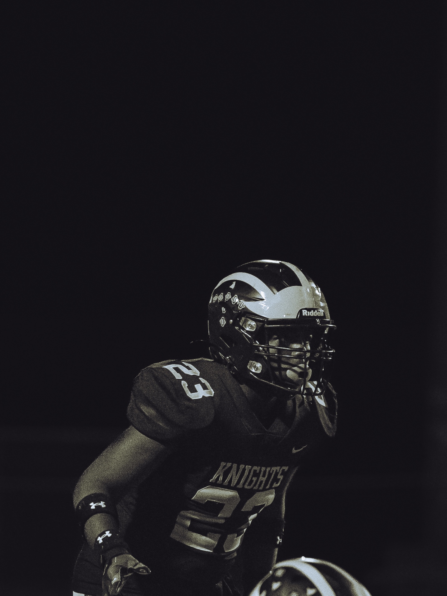 Knights football player under lights